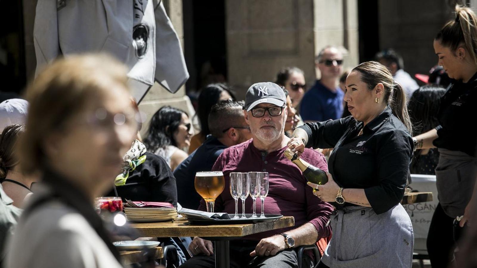 A waitress serving tourists on a terrace in Barcelona, in a file image.