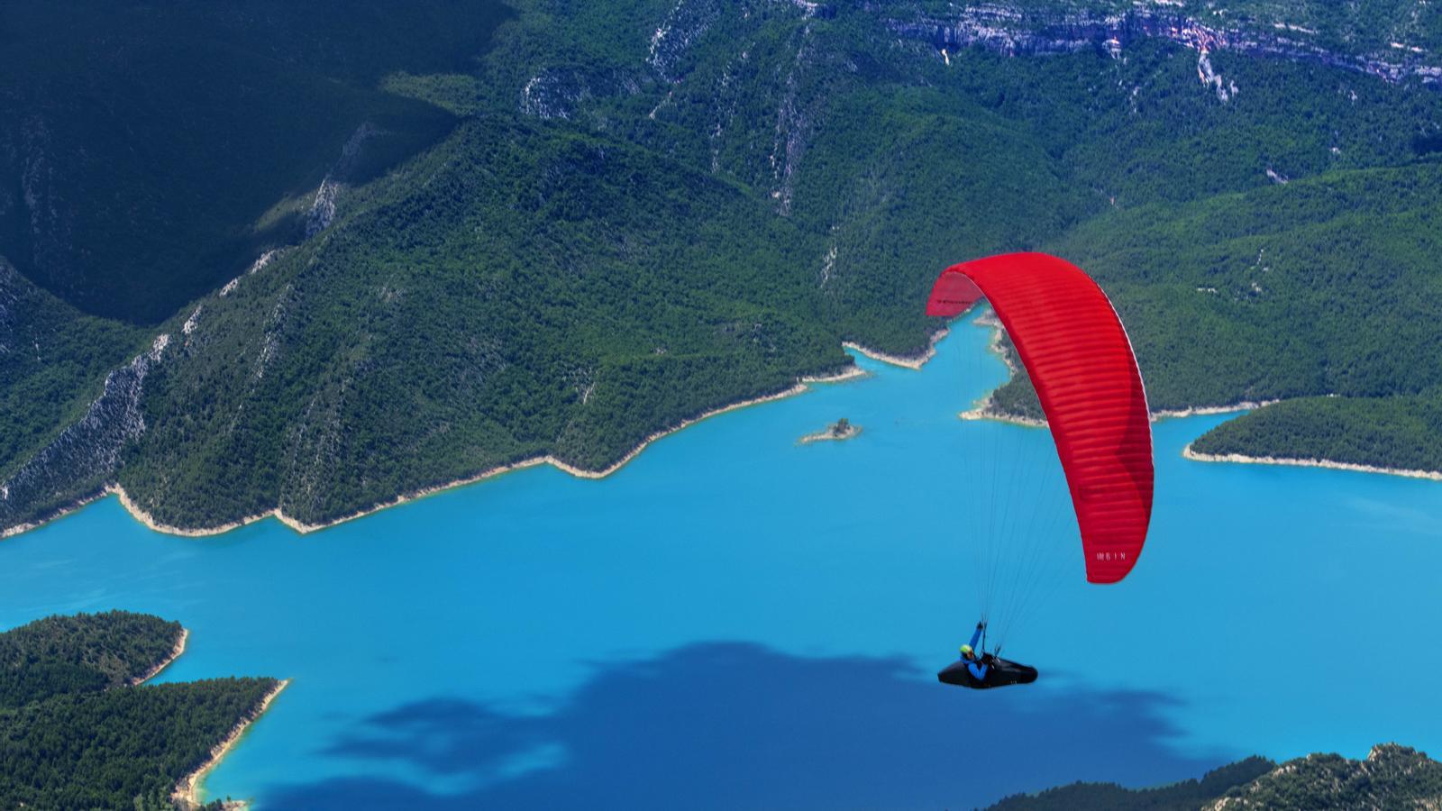 A paraglider flying in Àger