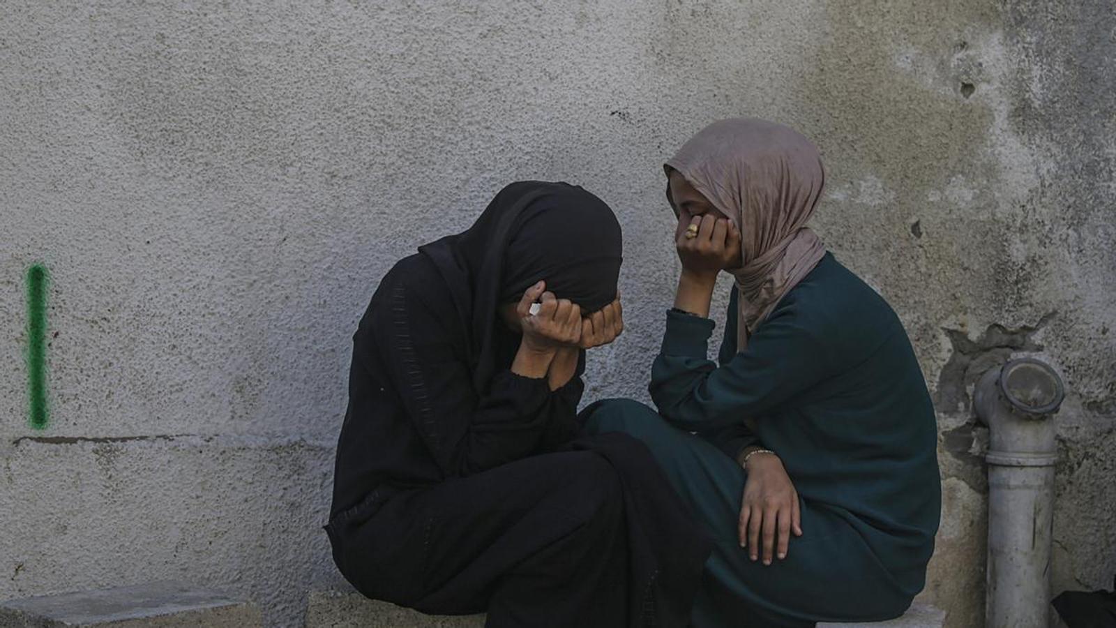 Two women mourn the deaths of relatives in a bombing in Gaza City.