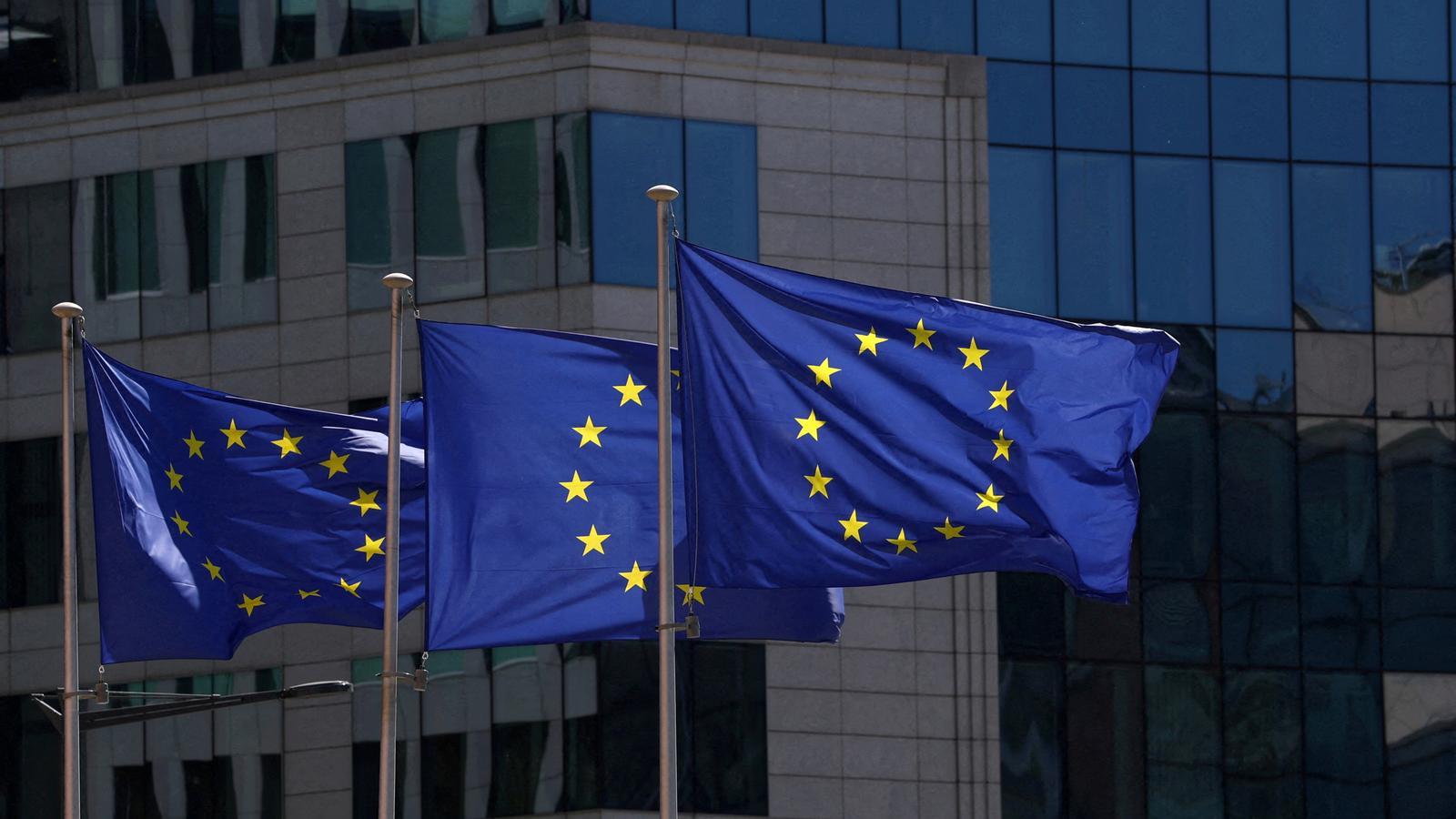 Flags of the European Union in front of the headquarters of the European Commission in Brussels, Belgium.