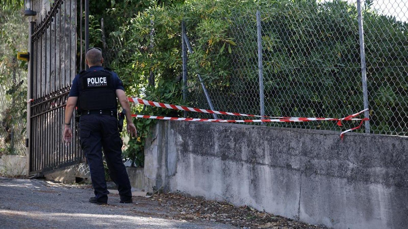 A police officer checking a hole in the outer fence of the Renoir Museum in Cagnes-sur-Mer.