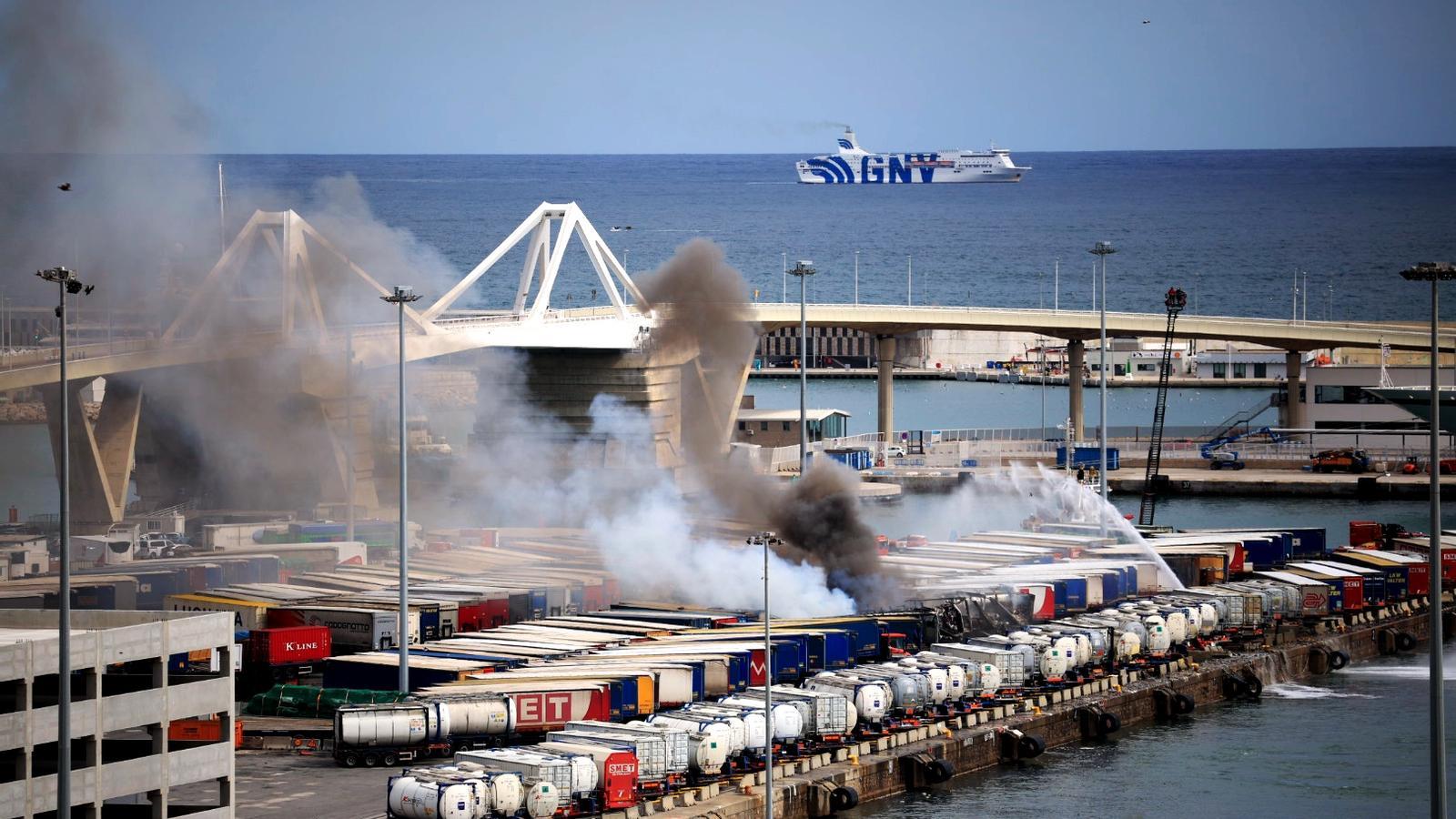 Firefighters are working to put out a fire in the Barcelona port area.