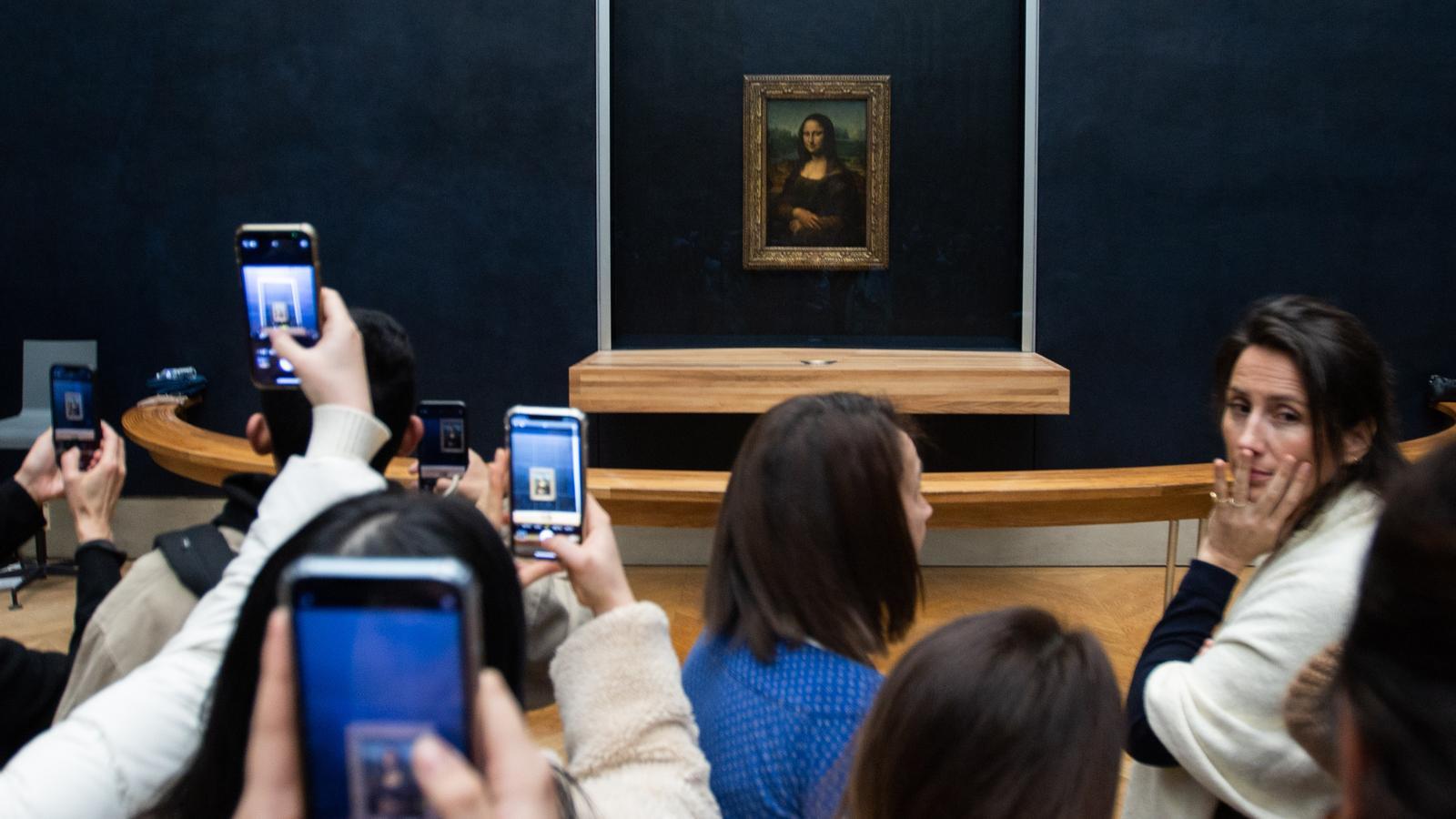 The Mona Lisa, also known as La Gioconda, a Renaissance work by Leonardo da Vinci, is seen by visitors to the Louvre Museum.