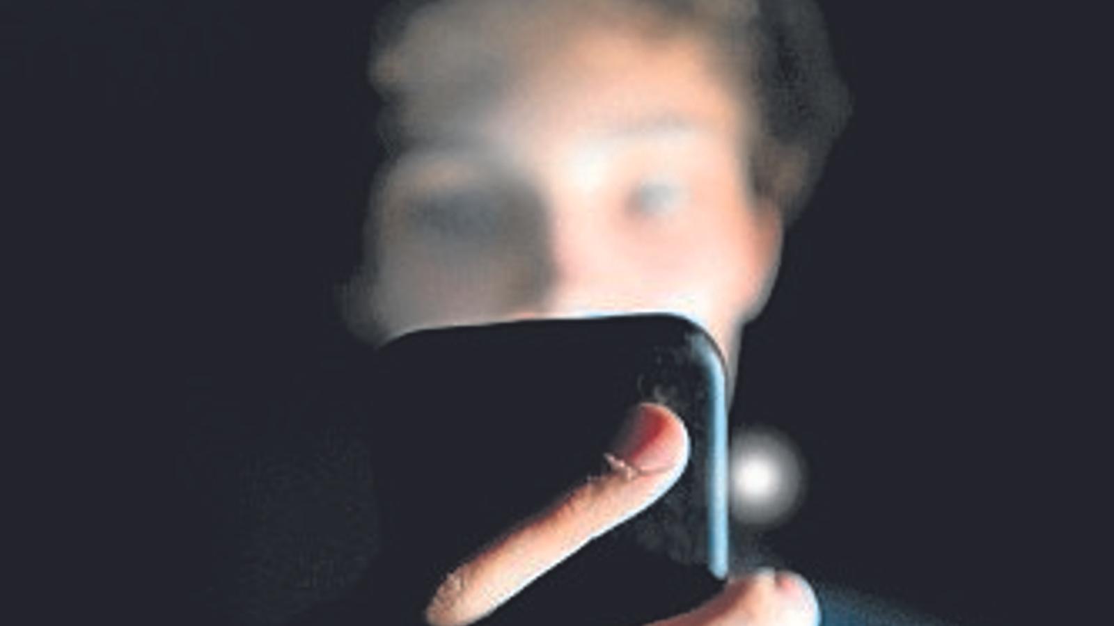 Un joven mirando el móvil