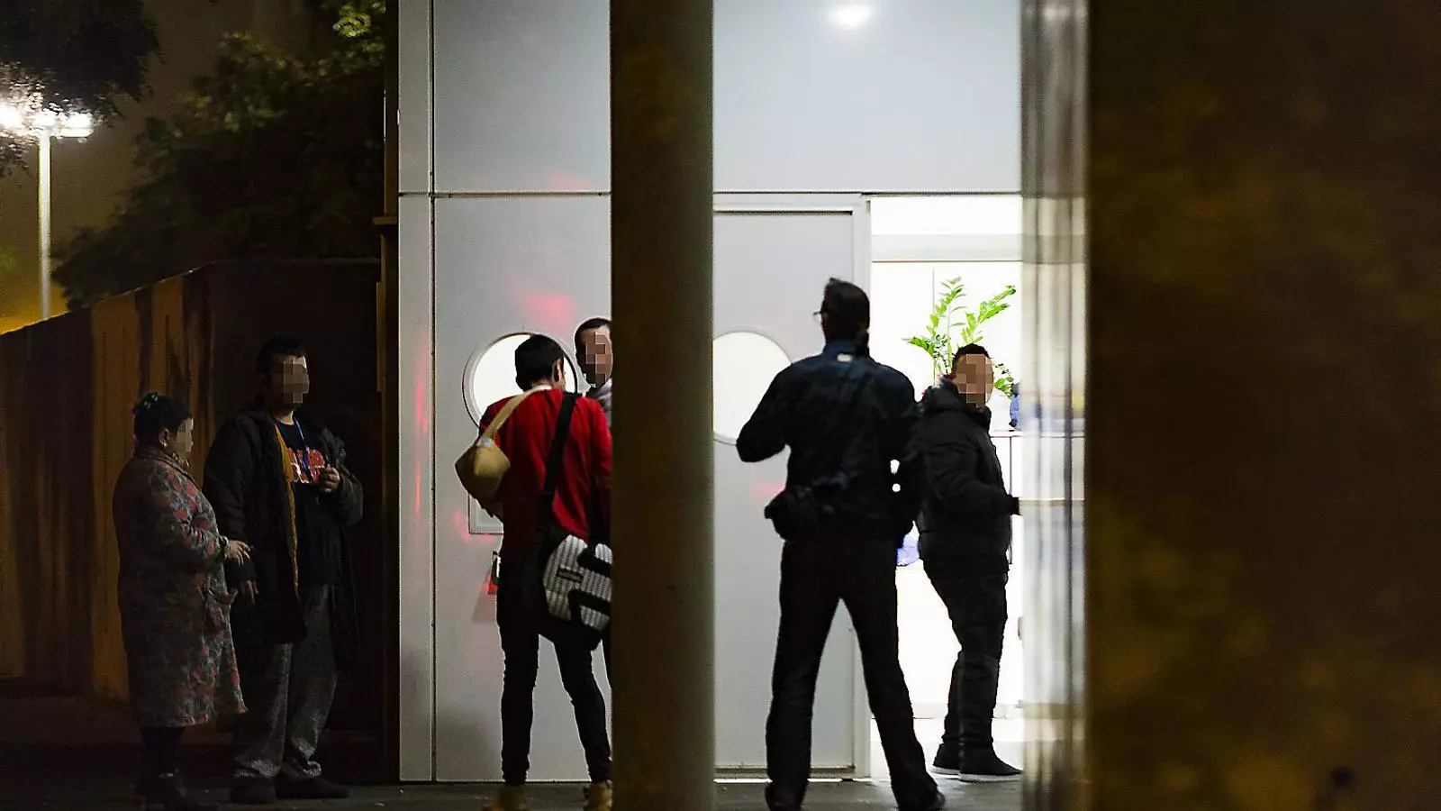 Usuaris i treballadors de la sala de venipunció de la Mina, a Sant Adrià de Besòs, conversant a la porta ahir a la nit.