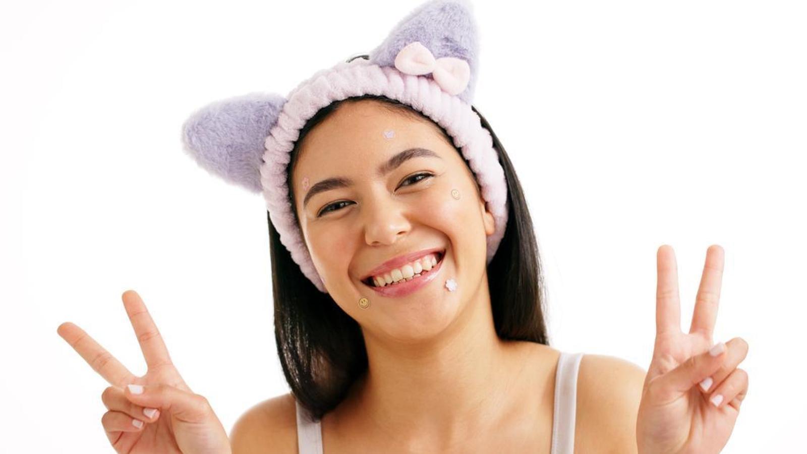 A girl with acne patches of different shapes and colors