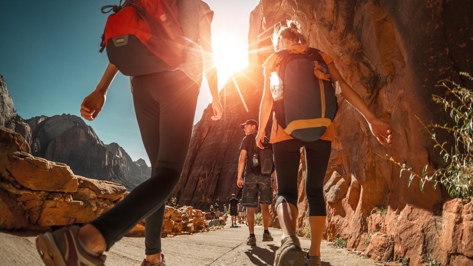 A group of tourists walking with backpacks, in a file image