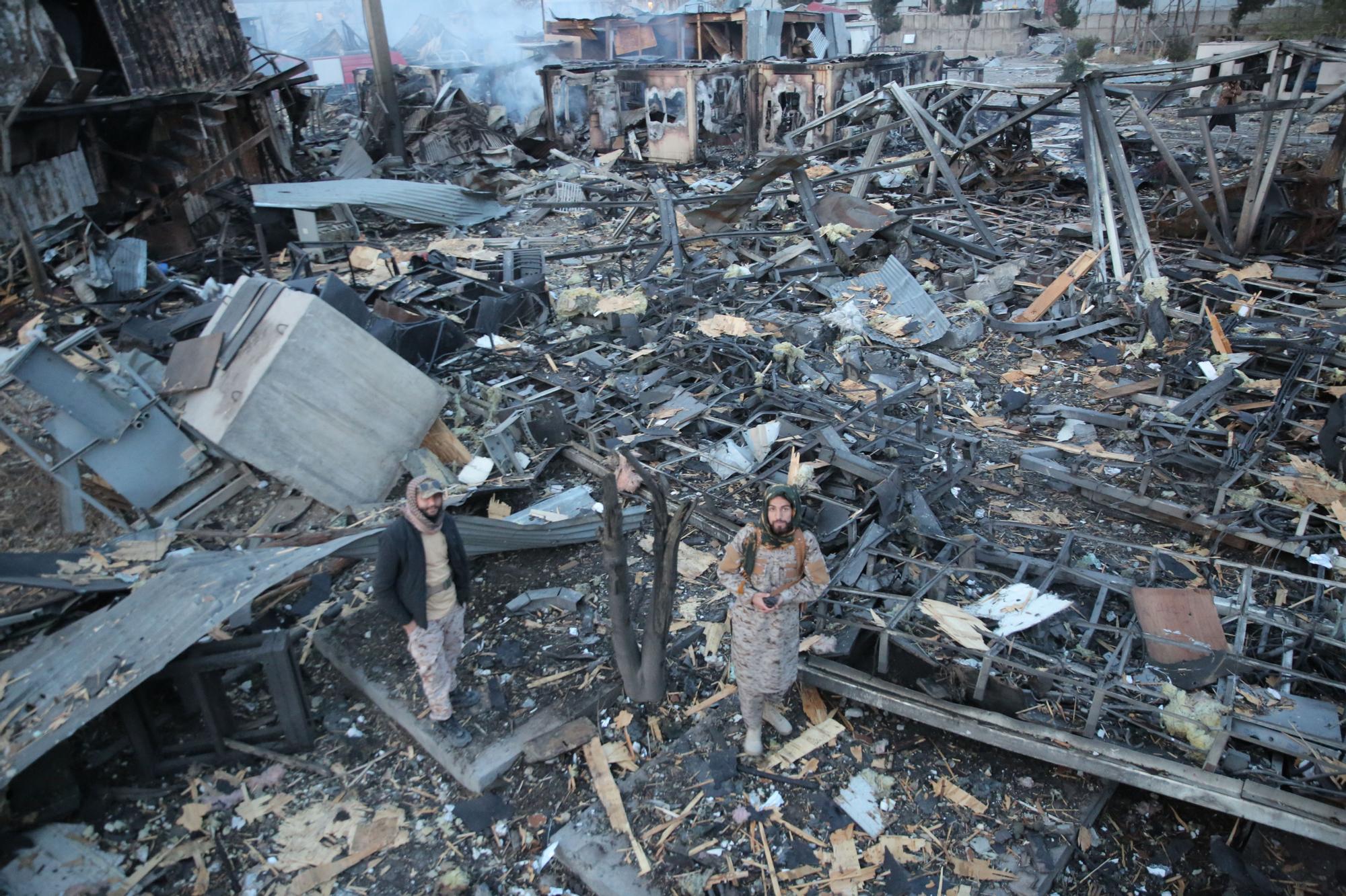 Taliban officers at the site of the blast, which was completely destroyed. The Taliban blame the Pakistani government, saying the building was a drug rehabilitation center.