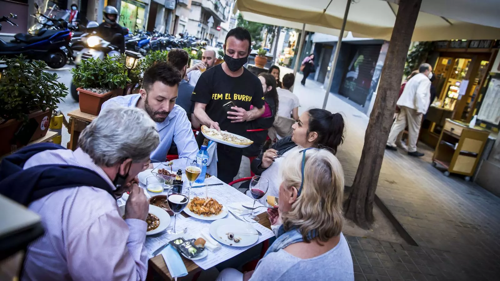 Gent sopant a la terrassa d'un restaurant