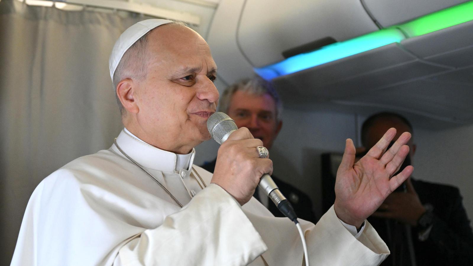 The Pope speaks with the press from the plane before flying to Algeria