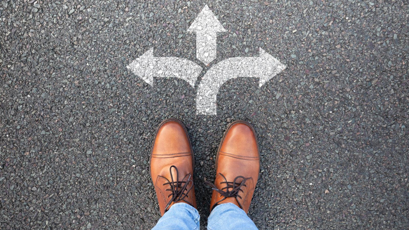 A person standing at a crossroads.