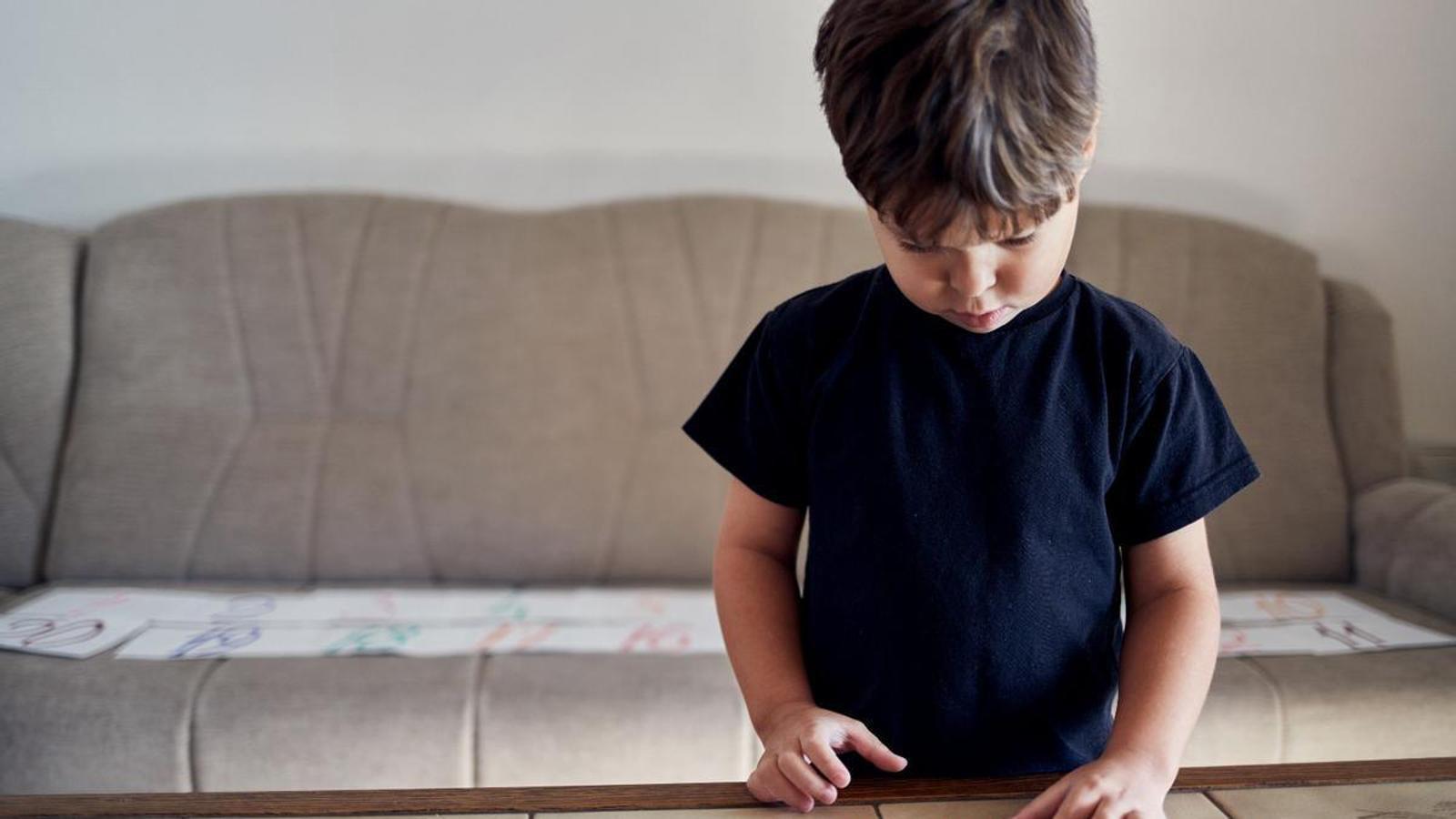 Exercises for fine motor skills development and mathematical skills development with an autistic child, in a stock image.