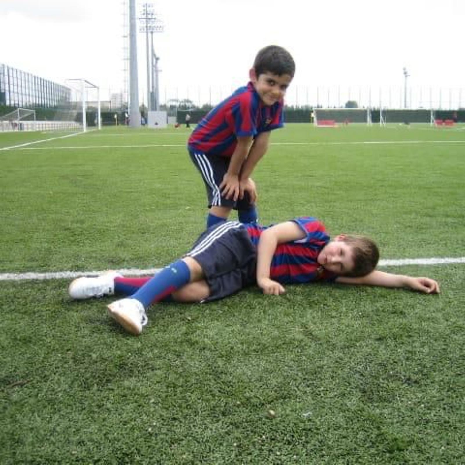 Twin soccer players at a training facility.