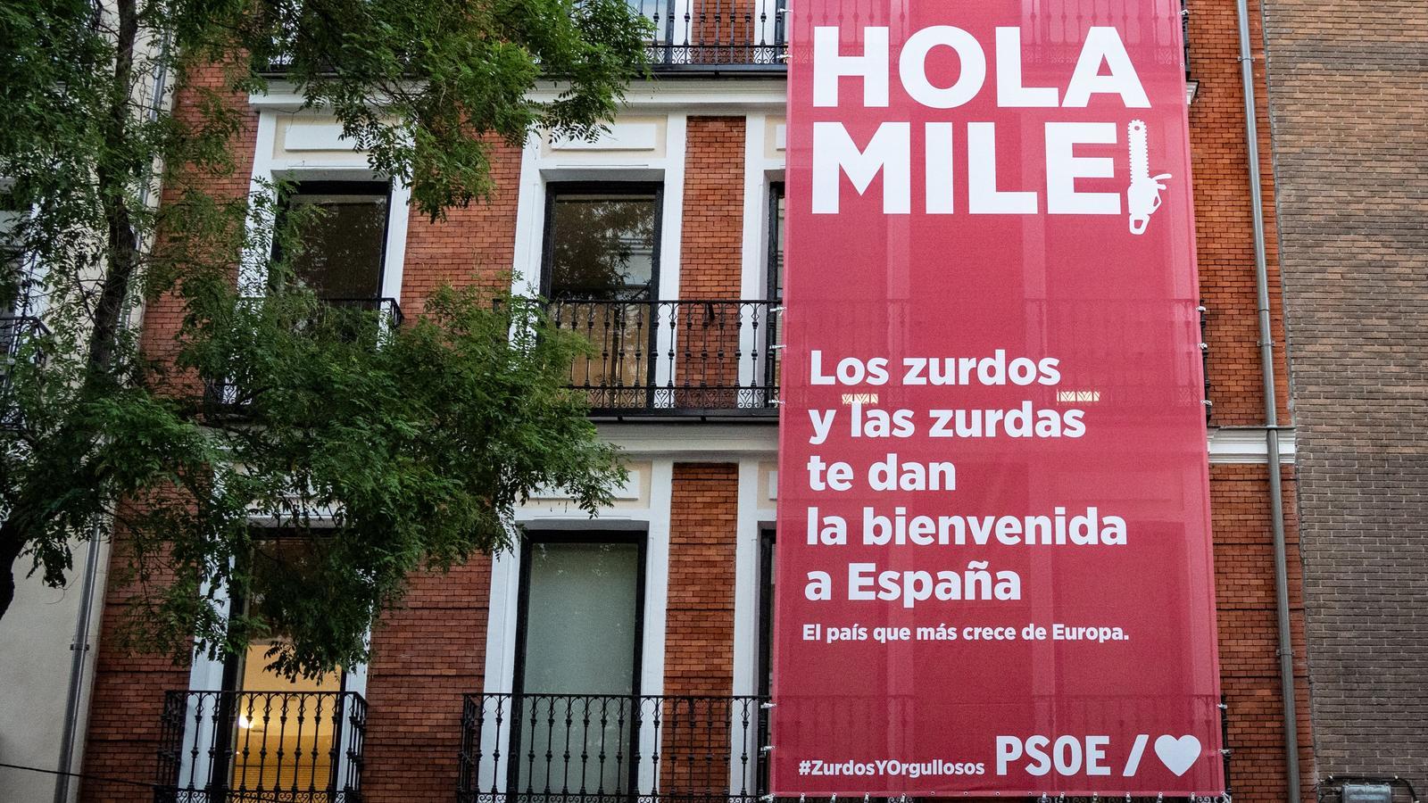 The socialist party hangs a canvas at its headquarters in Madrid to receive Javier Milei