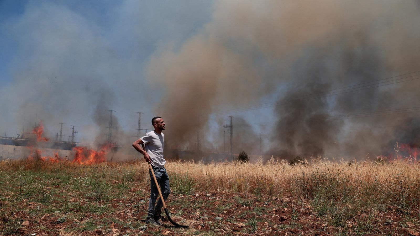 Un hombre palestino observa un campo en llamas por un incendio provocado por colonos israelíes en Huwwara, cerca de Nablus, en Cisjordania, el 6 de junio de 2026.