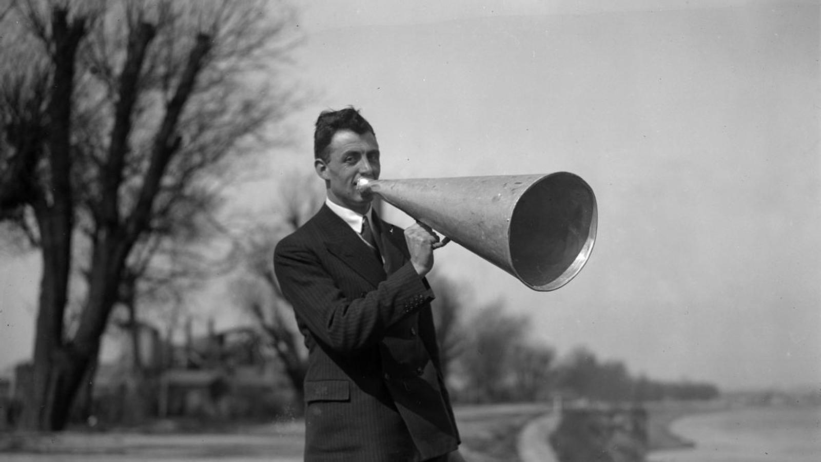 A man speaks through a megaphone.
