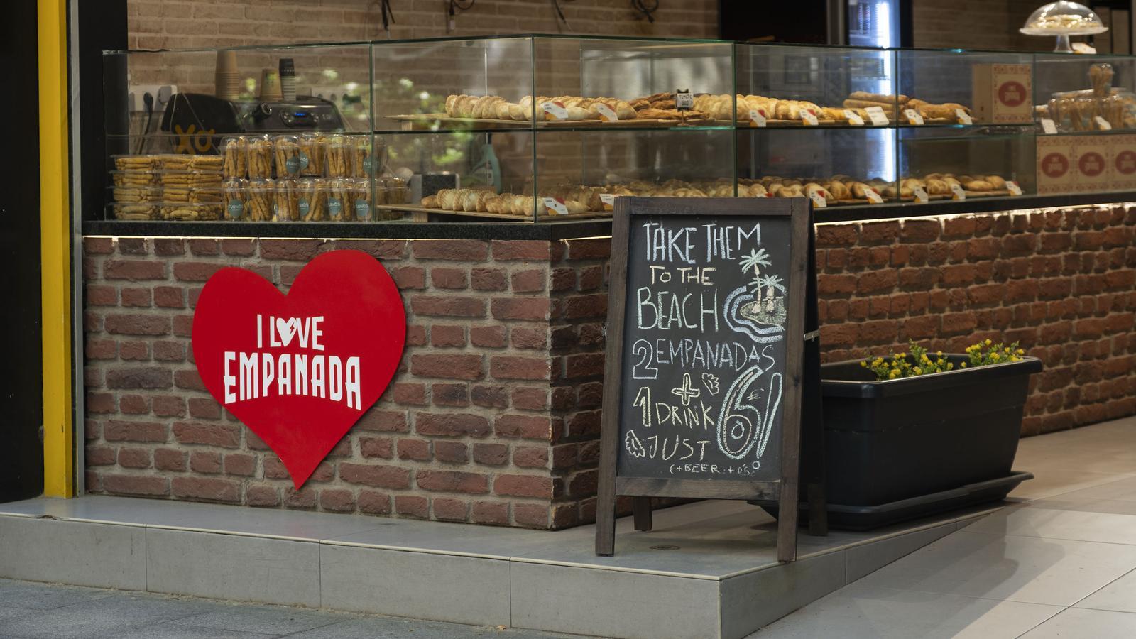 Cartel en inglés en una tienda de empanadas en la rambla del Poblenou.