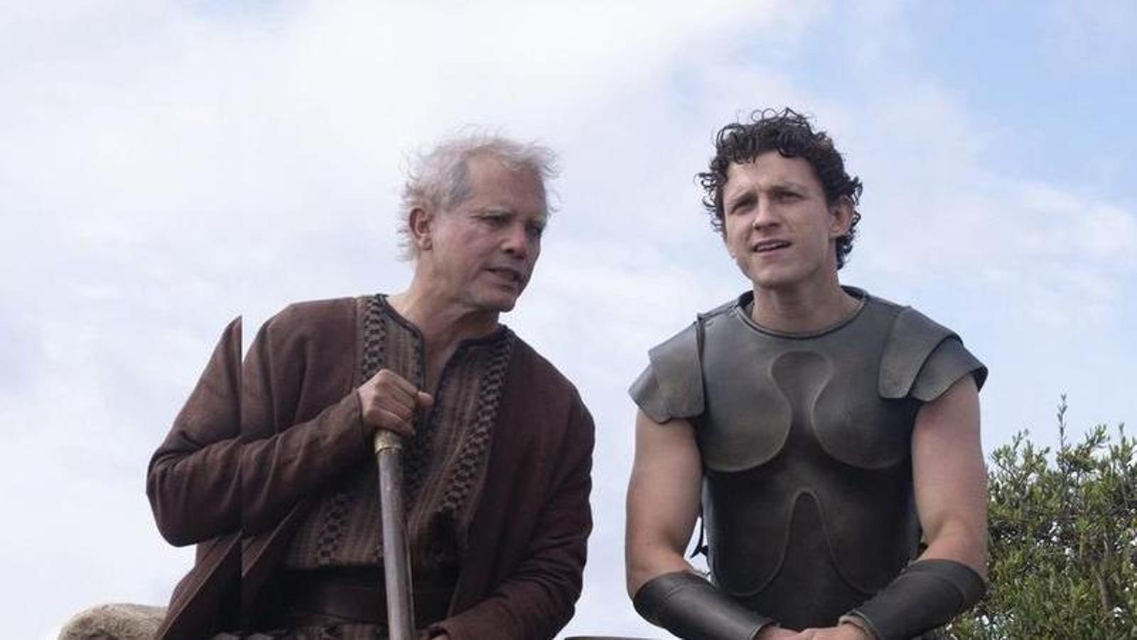 John Leguizamo in the role of Eumeu, on the left, and Tom Holland as Telemachus, in a promotional image for Christopher Nolan's 'The Odyssey'.