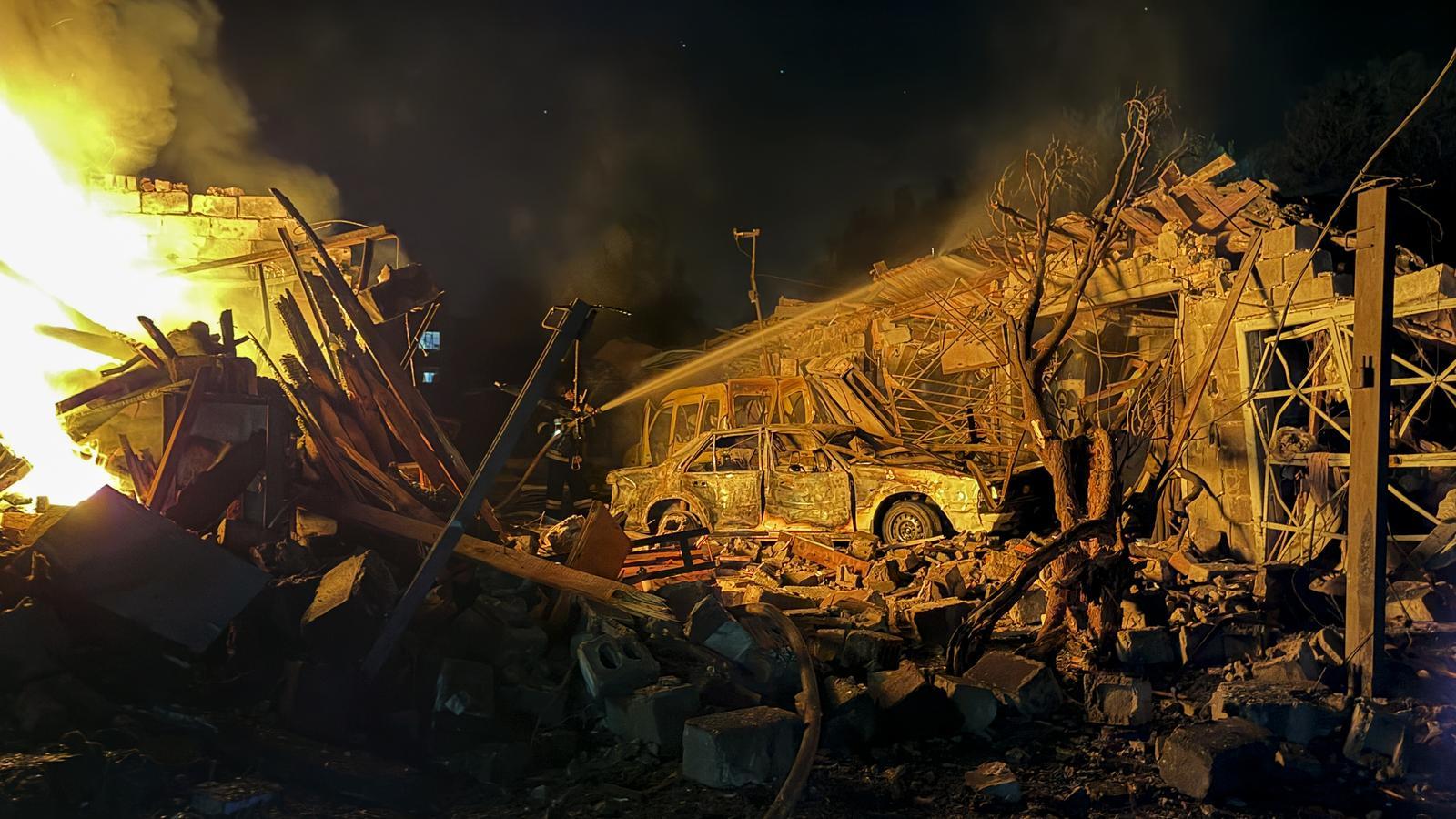 Ukrainian rescuers work at the site of a Russian attack in a residential area in Zaporizhzhia, last night, August 11, 2026