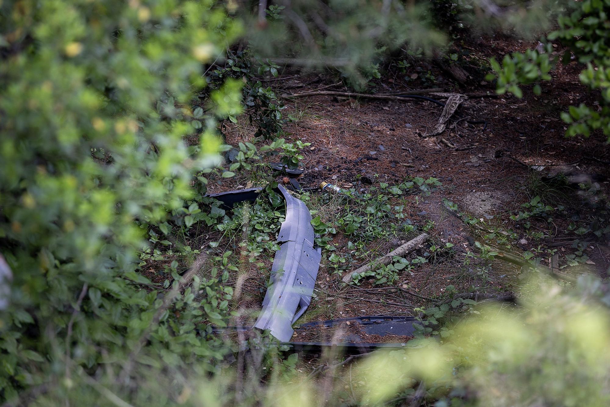Wrecked vehicles at the bottom of a ravine.