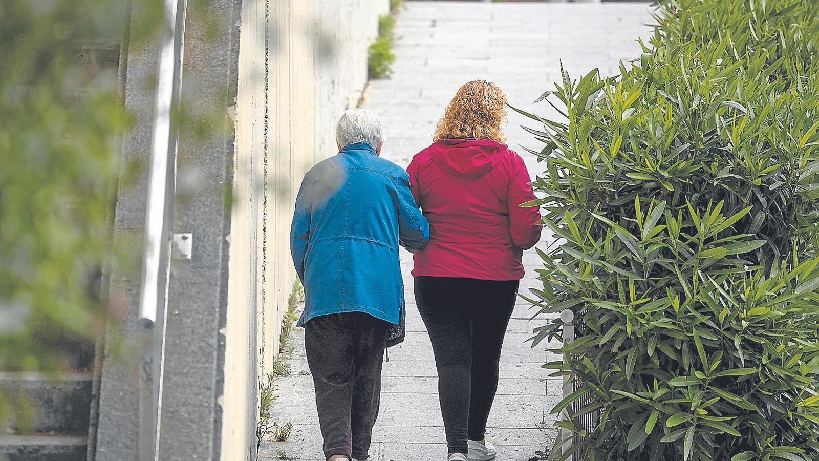 A worker is a caregiver to an 88-year-old woman in the Barcelona neighborhood of Guinardó.