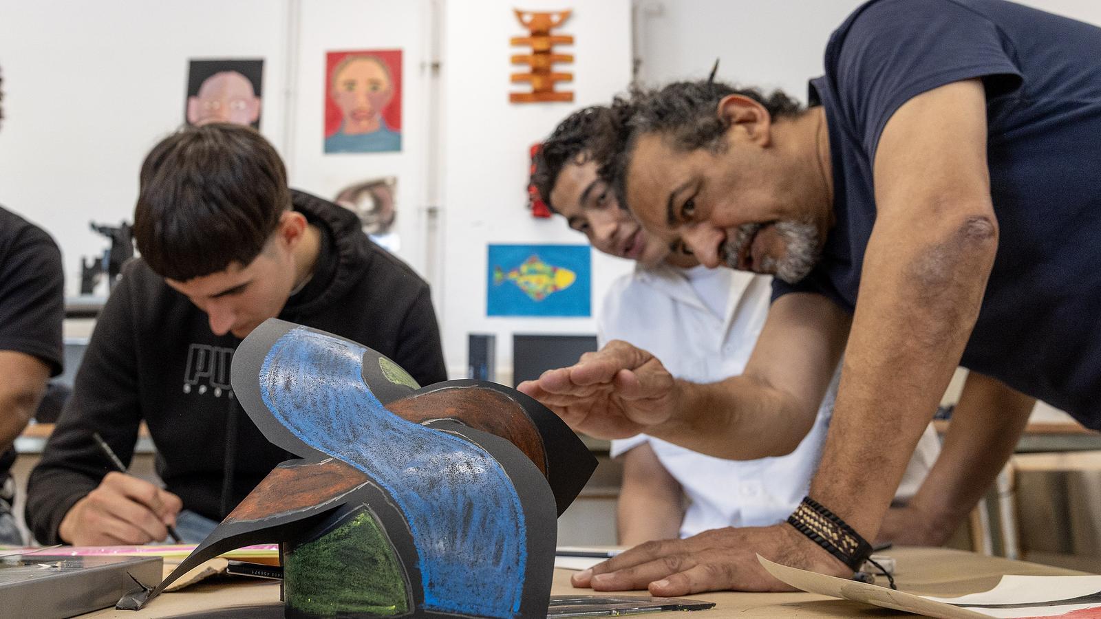Joel, 'Pantera' and Agustín in the classroom during the plastic arts workshop.