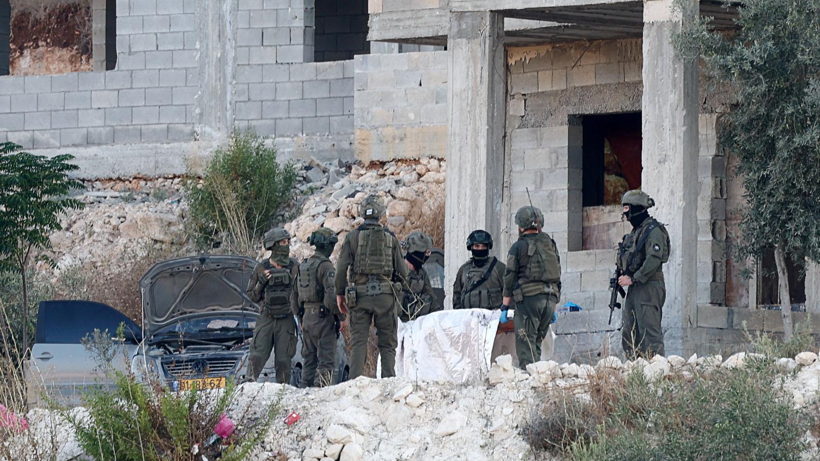 Israeli soldiers carry the body of a Palestinian after an Israeli military airstrike in Jenin, in the Israeli-occupied West Bank.