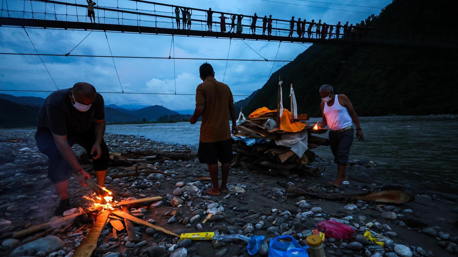 A funeral for a victim of the flood in the Suryamati river.