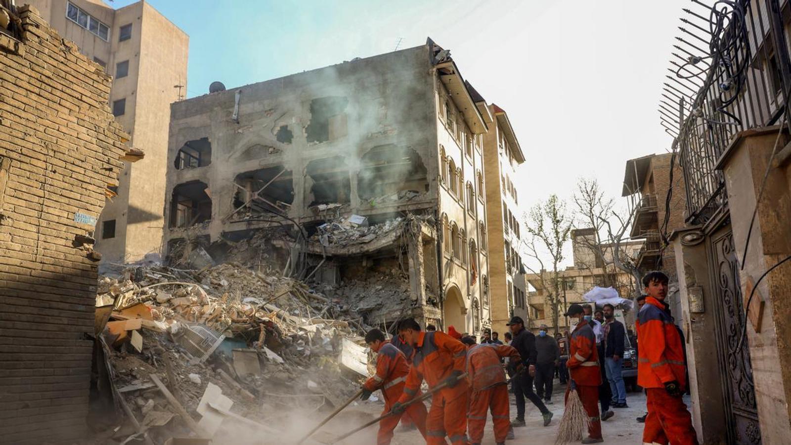 Iranian workers clean around a destroyed Khorasaniha synagogue in Tehran, Iran.