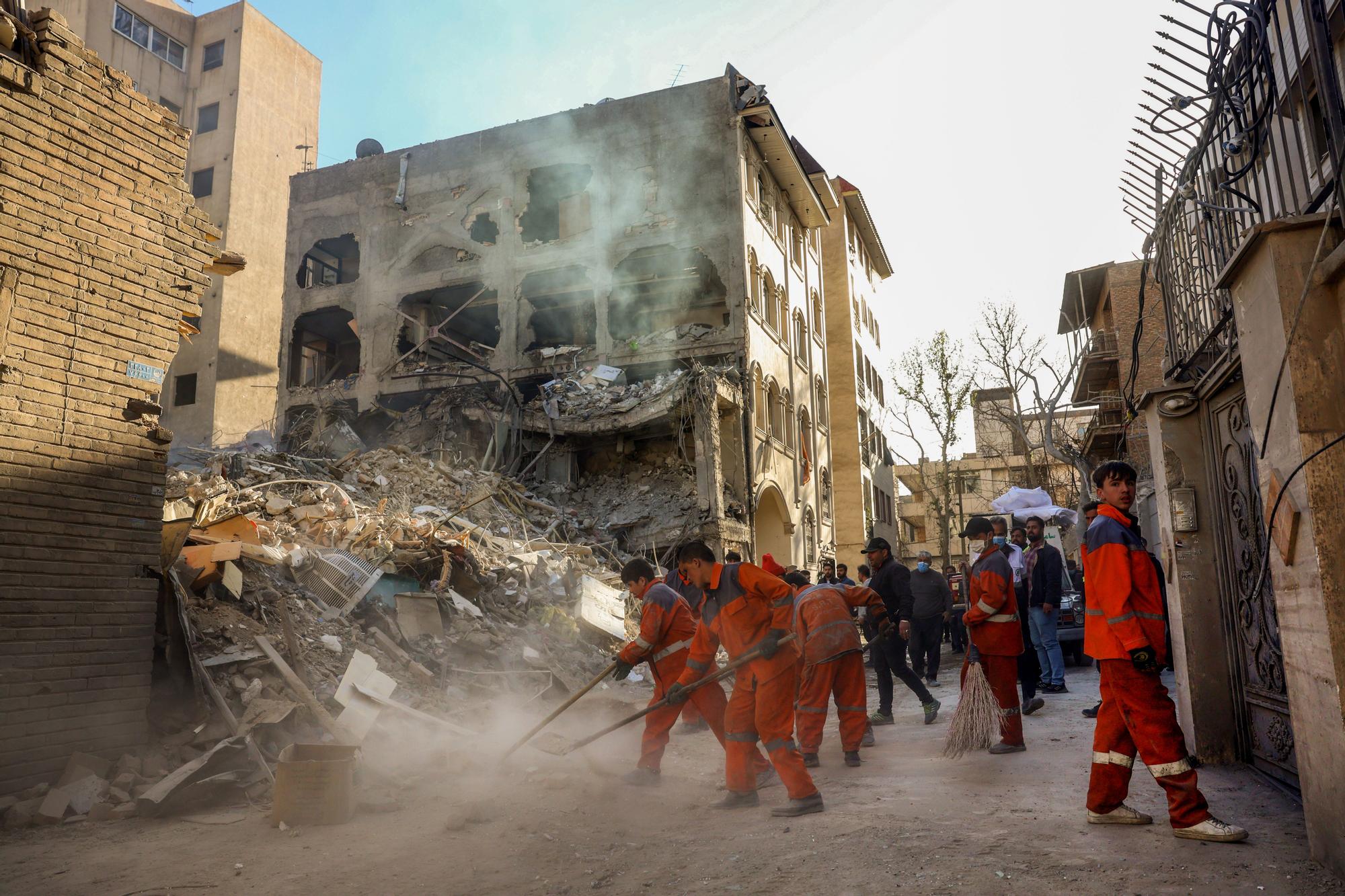 Treballadors iranians netegen al voltant d'una sinagoga Khorasaniha destruïda a Teheran, Iran.