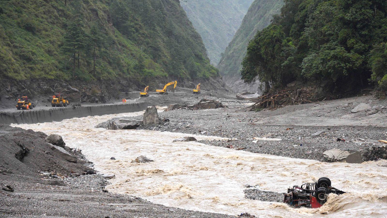 Excavators and loaders in full work while rescue teams repair a road leading to the port of Gyirong after a mudslide, in Gyirong County (Shigatse, Tibet Autonomous Region, China), on August 28, 2026.