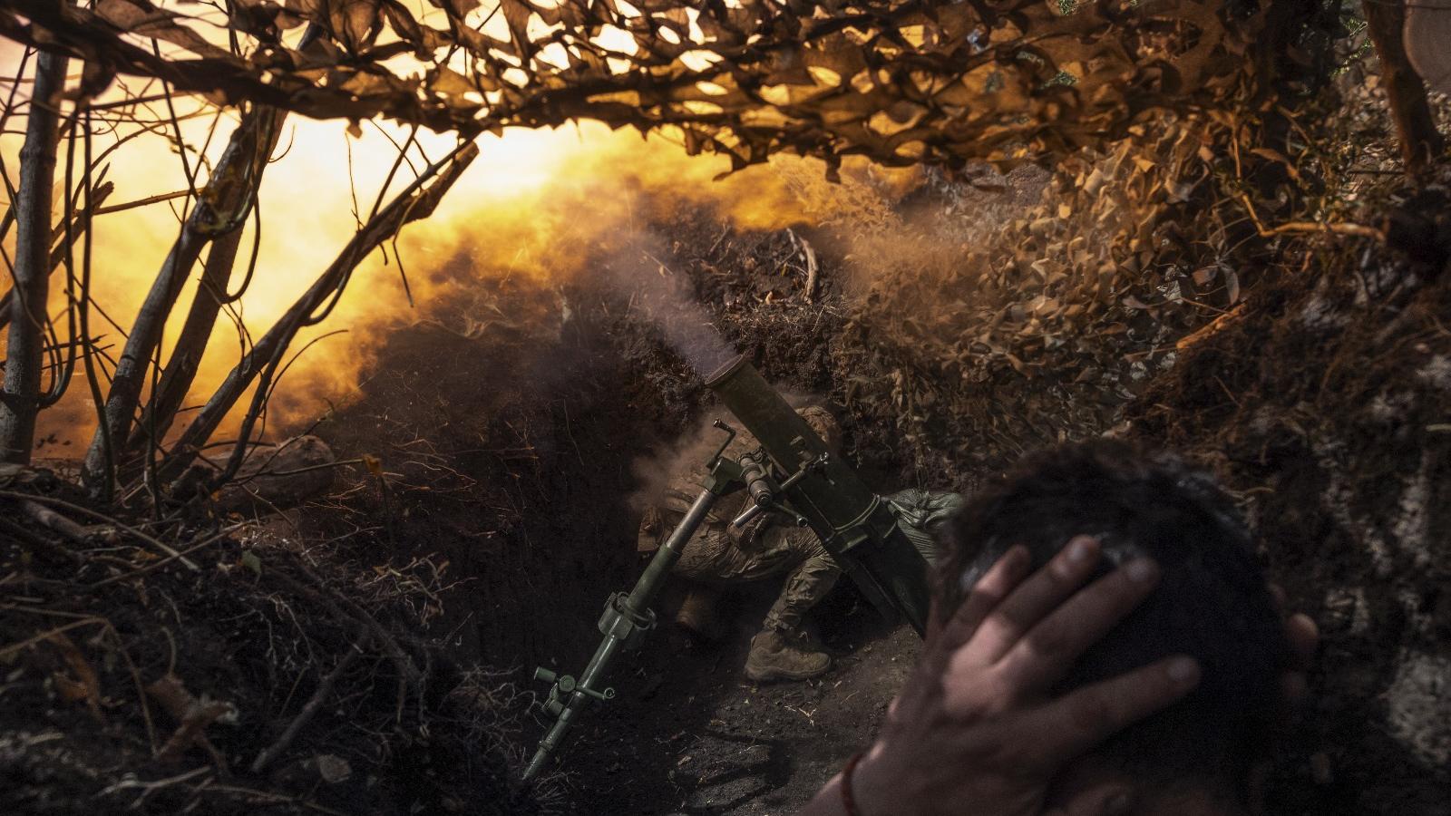 A Ukrainian soldier fires mortar fire from somewhere on the Donetsk front near Konstantinvka.