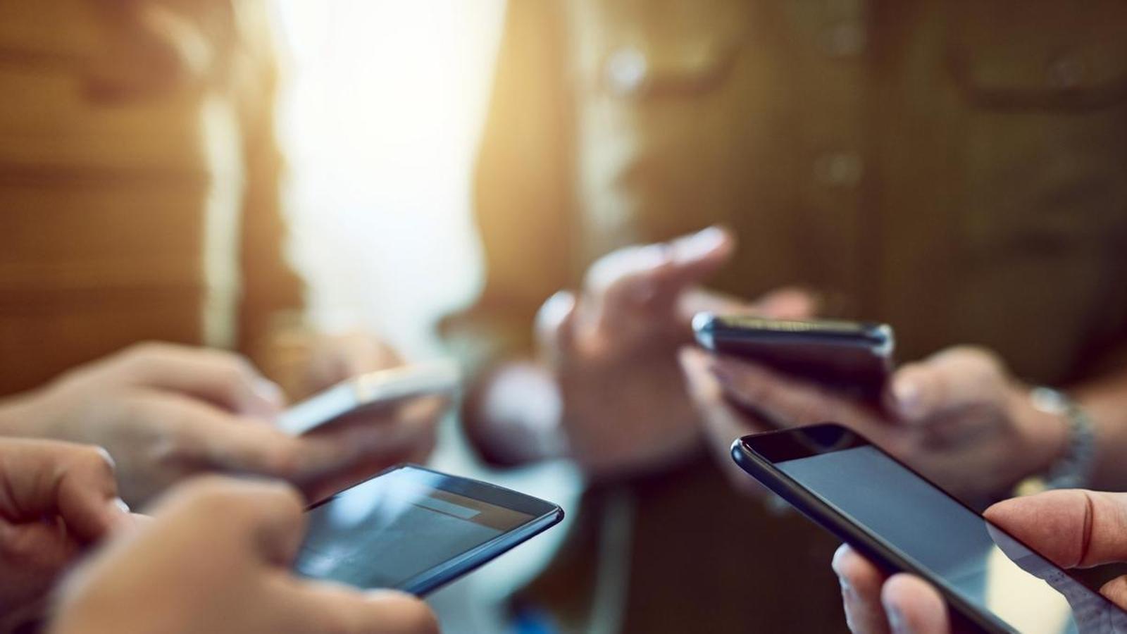 Young people with mobile phones.
