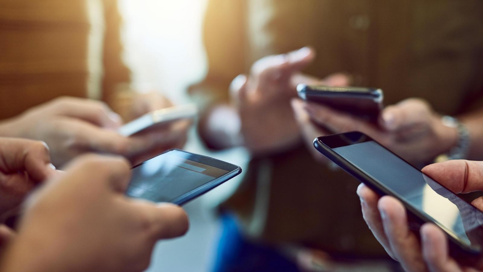 Young people with mobile phones.