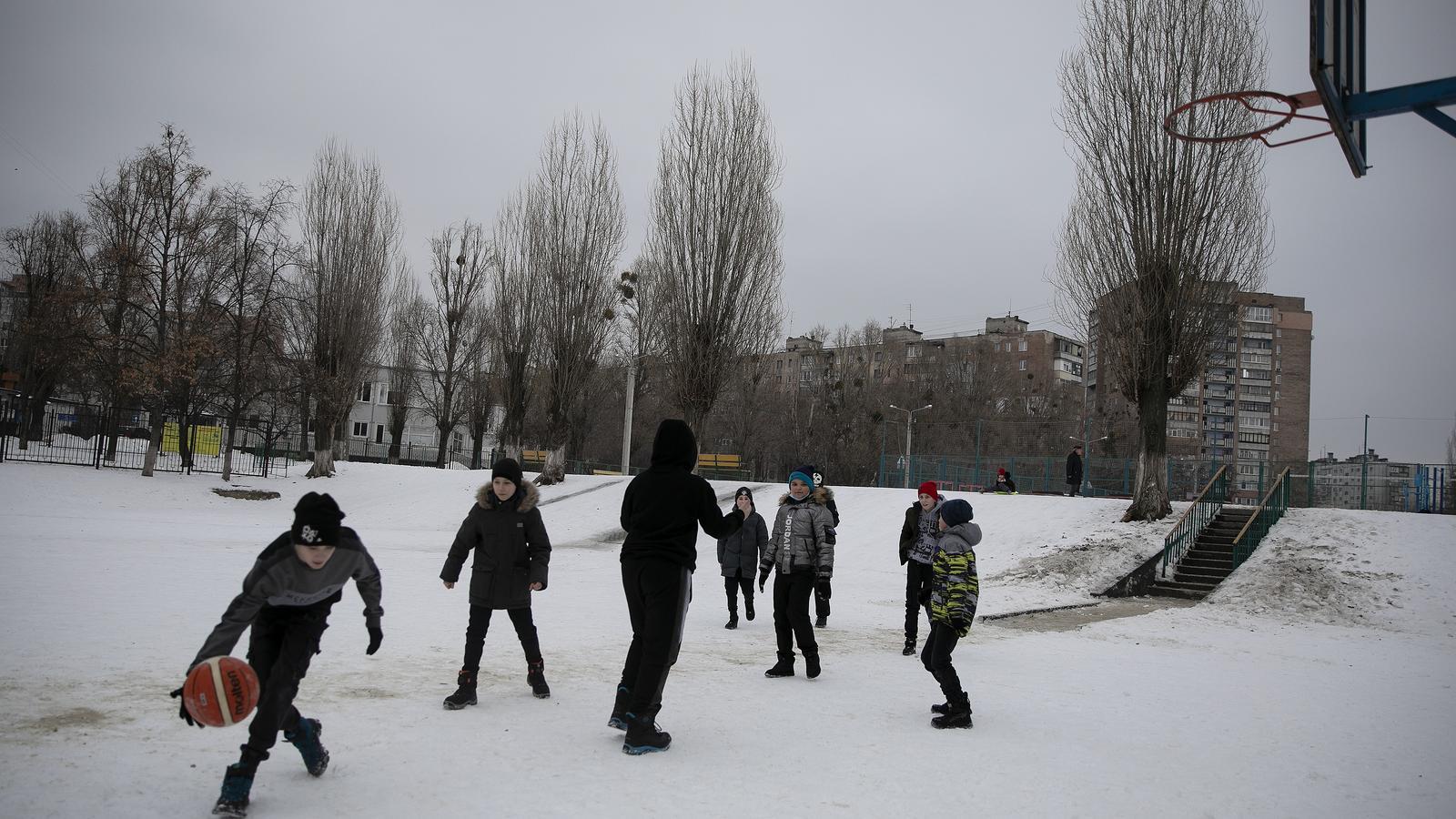 Children playing basketball in the school playground in Oso nueva, a working class neighborhood of Kharkiv