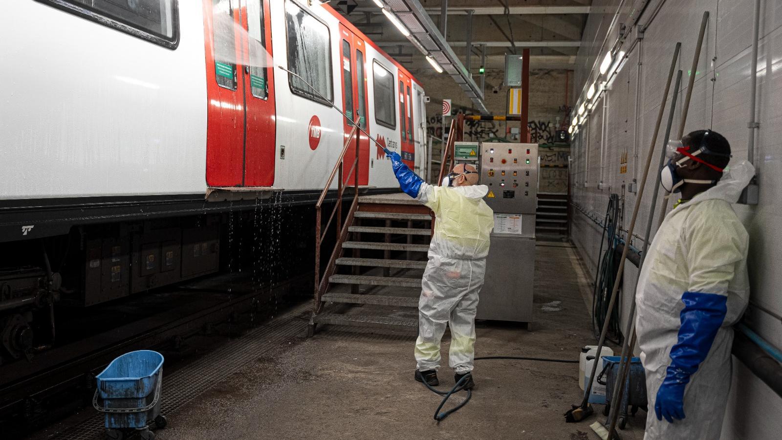 Workers cleaning a subway train on line L1 of the Barcelona metro