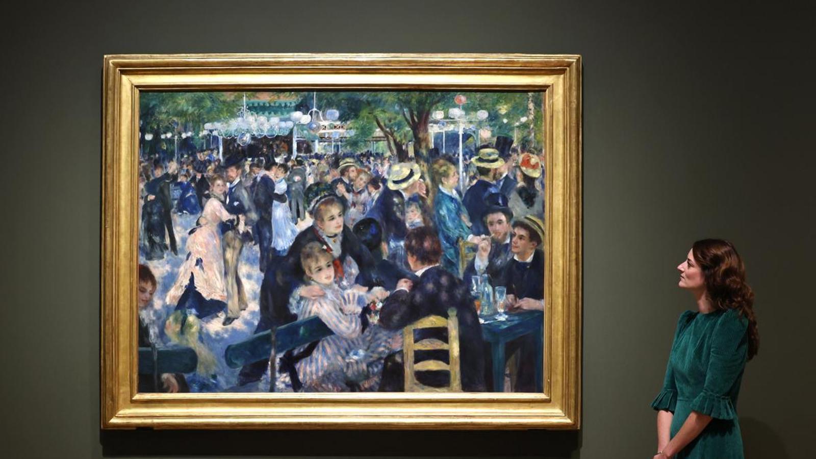 Megan Renoir looking at the painting 'Bal du moulin de la Galette' (1876), by Pierre-Auguste Renoir, at the 'Renoir and love' exhibition at the National Gallery in London.
