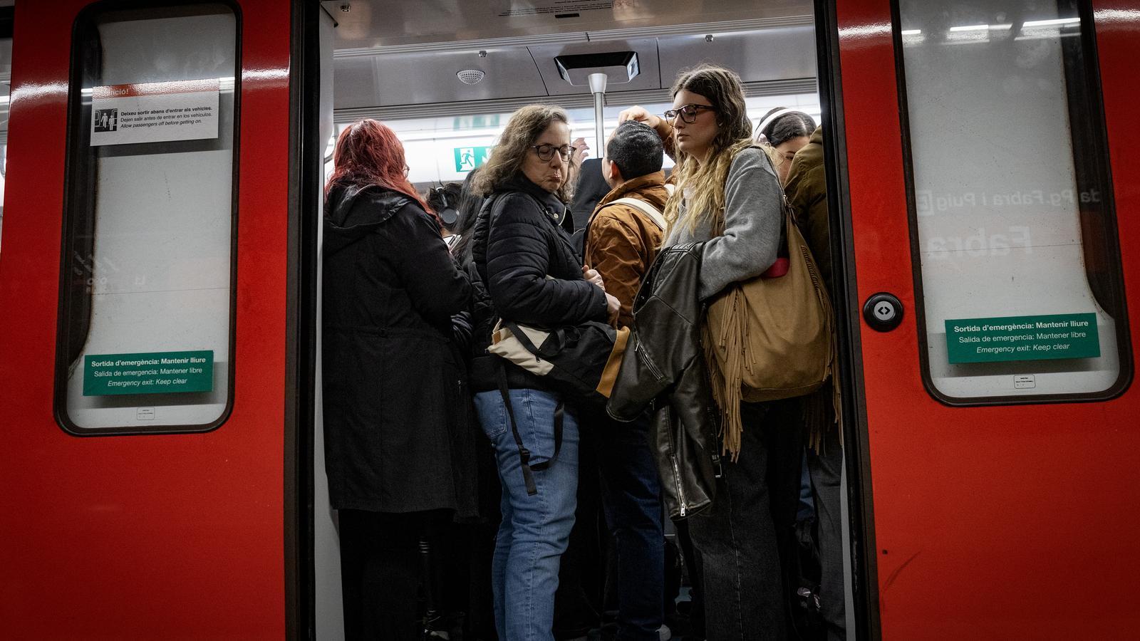 Metro users packed together at the Fabra i Puig station in Barcelona.