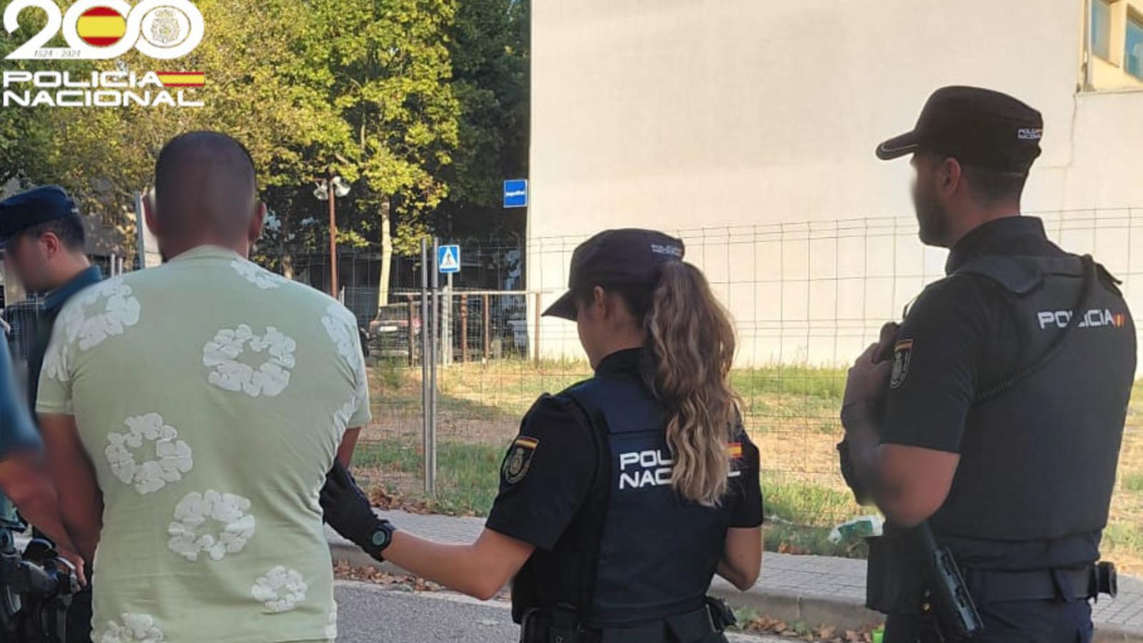 National Police officers with the detainee