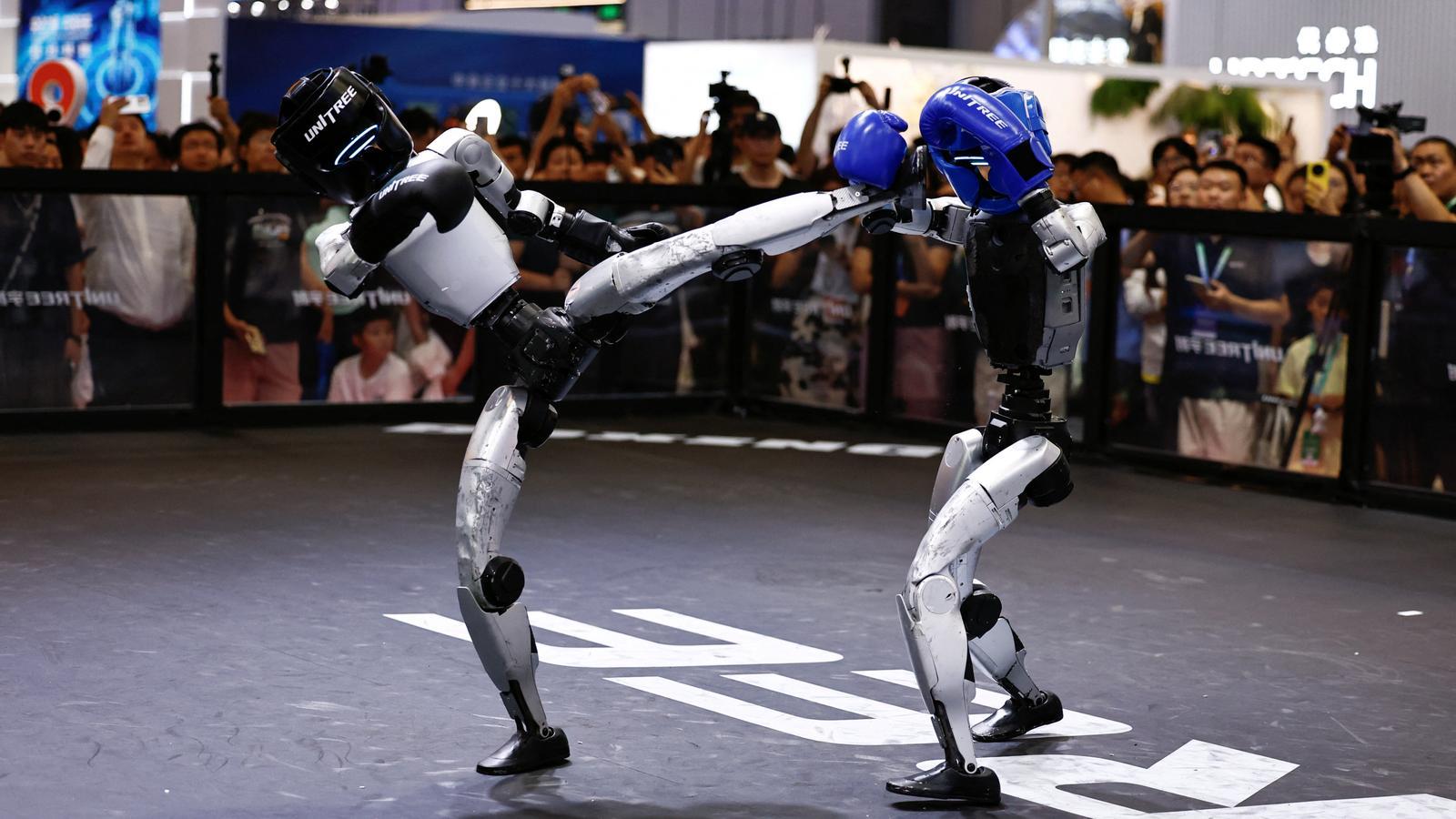 Two humanoid robots from the Chinese company Unitree in a kickboxing demonstration during the World Robot Conference held in Beijing.