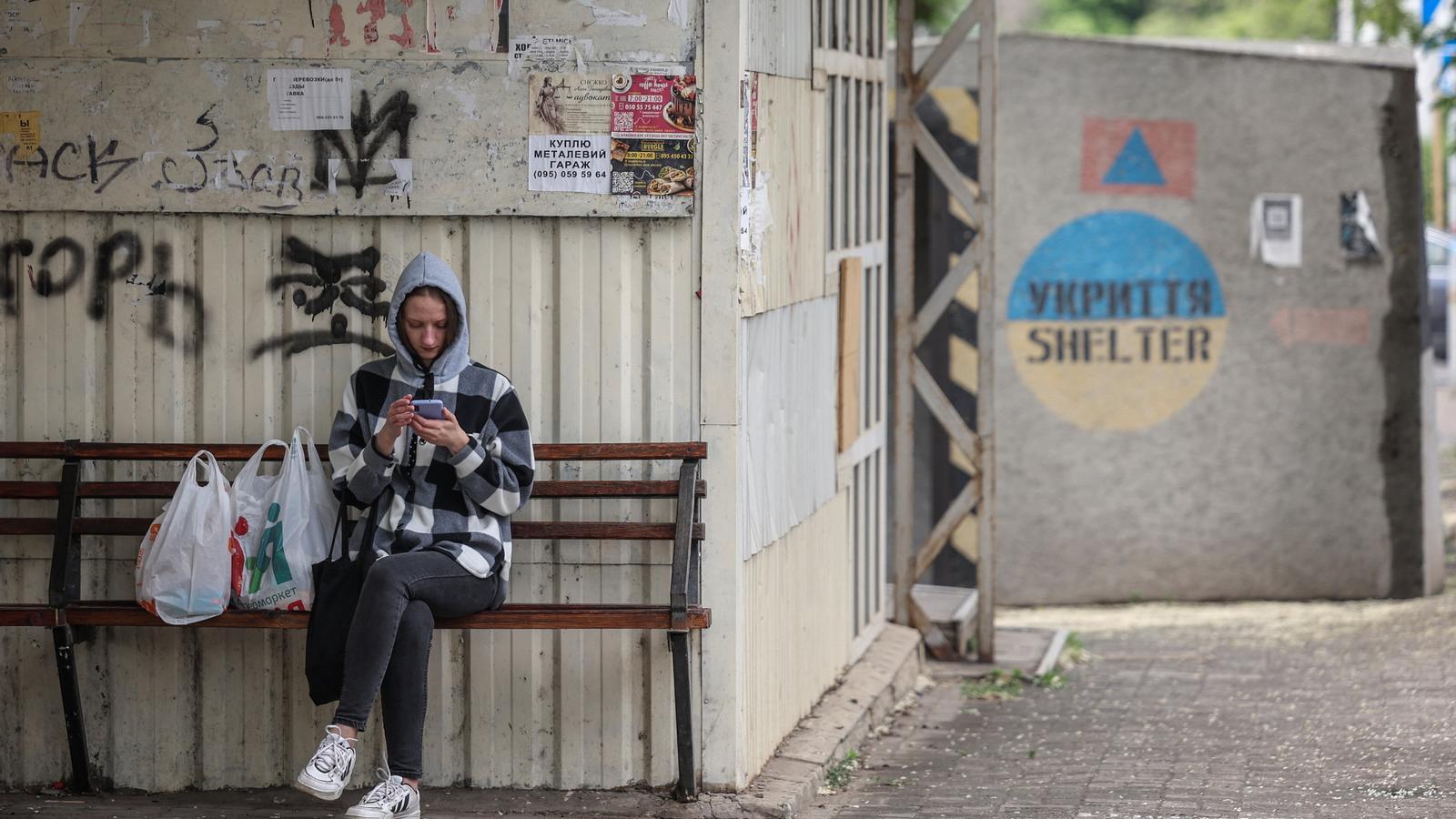 Una mujer revisa su teléfono móvil en una calle de la ciudad ucraniana de Kramatorsk, en el Donbás.