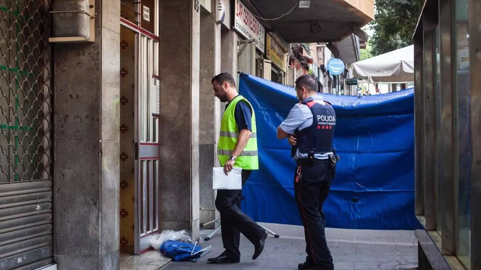 Agents dels Mossos, a la porta de l'edifici on s'han produït el doble homicidi per un afer de drogues a Santa Coloma de Gramenet