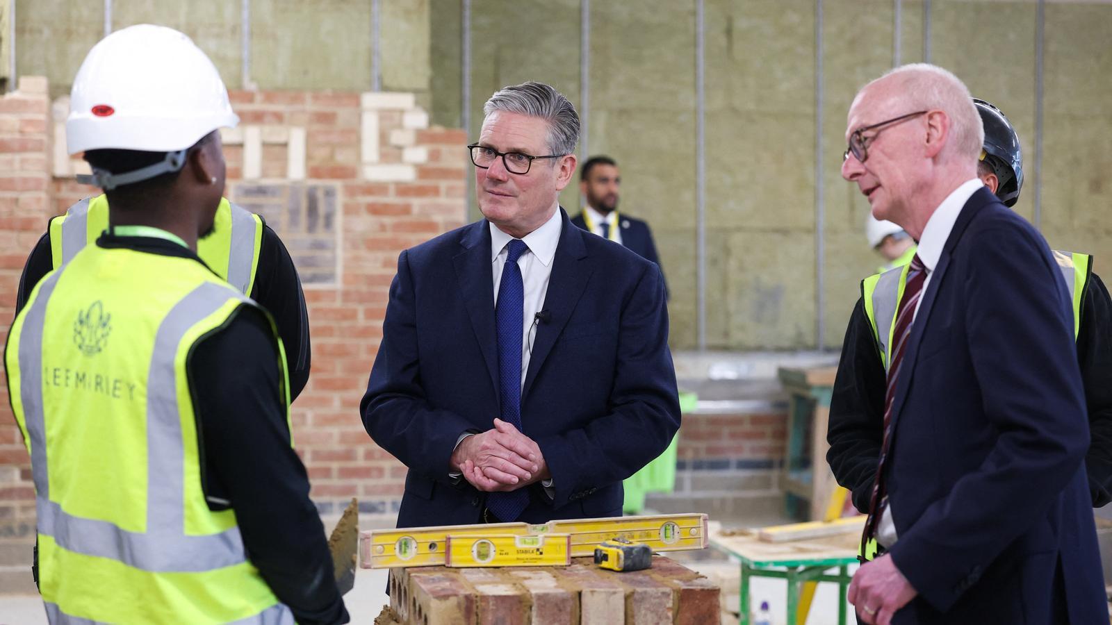 Keir Starmer, British Prime Minister, and the Secretary of State for Work and Pensions, Pat McFadden, during a meeting, this Tuesday evening, with apprentice bricklayers, during a visit to London South Bank Technical College, in the British capital.