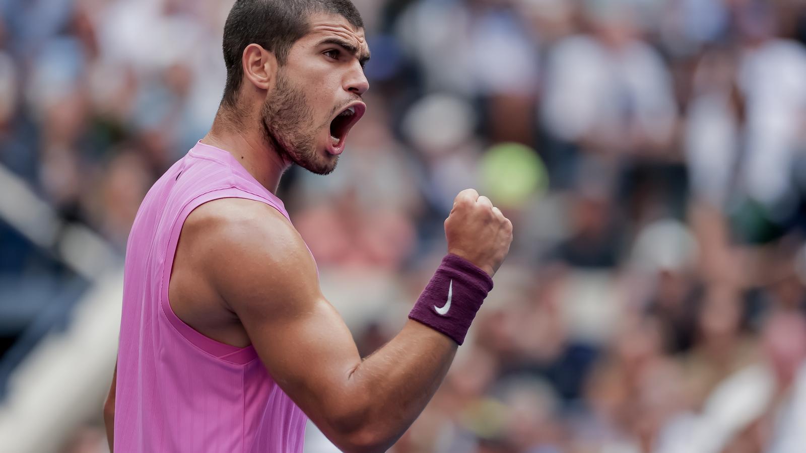 Carlos Alcaraz celebrates a point against Novak Djokovic.