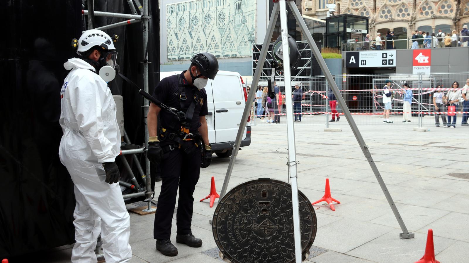 Agentes de los Mossos revisando el alcantarillado alrededor de la Sagrada Familia con motivo de la visita del Papa.