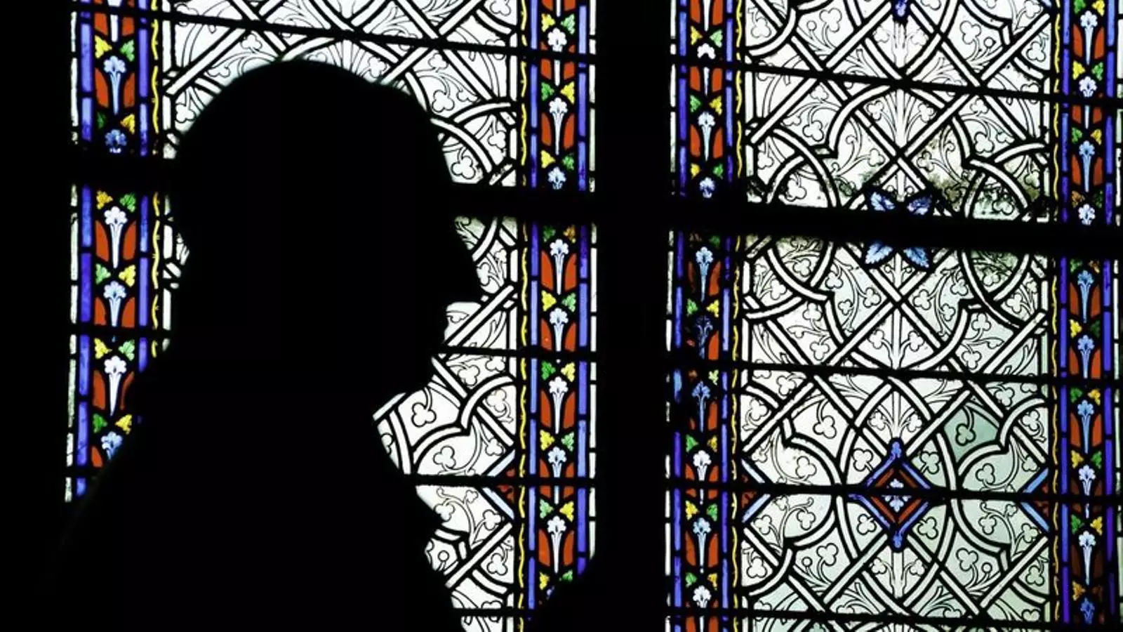 Un home resant en una església, en una imatge d'arxiu