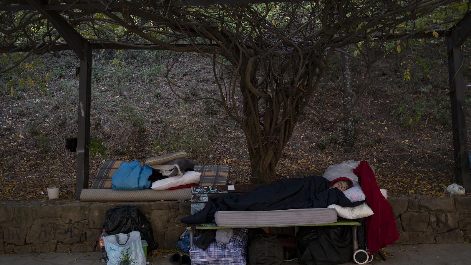 A person sleeping in a homeless camp in Montjuic.