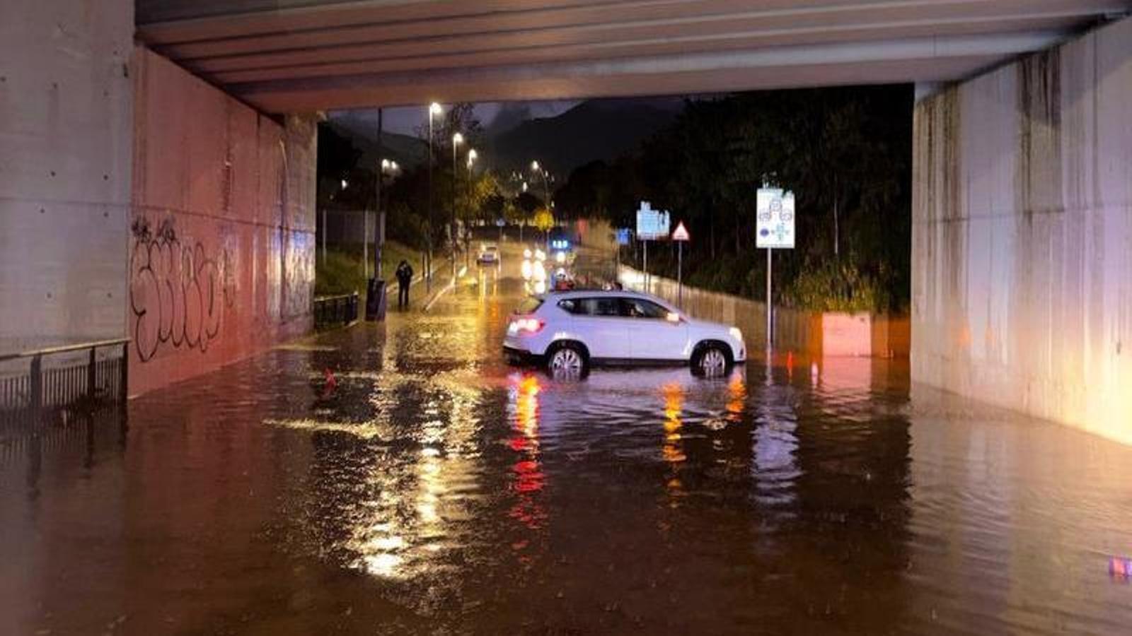 A car stuck in an underpass during a rainstorm in Barcelona.