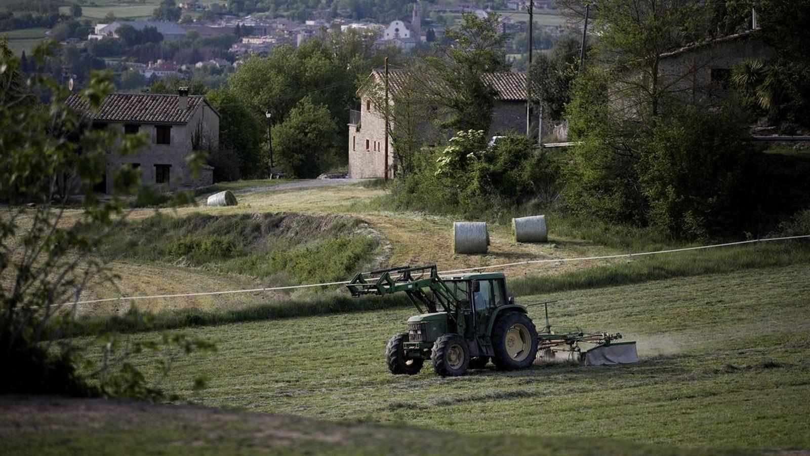 Farmers working with the tractor in Sobremunt.