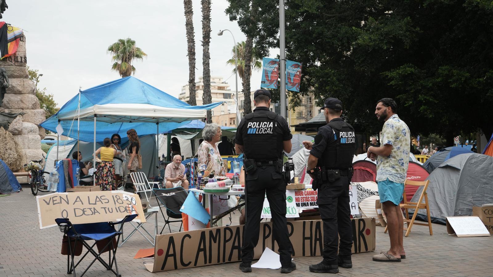 Local Police agents doing a check at the housing encampment.
